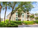 Attractive condo exterior featuring lush landscaping, mature trees, and reserved parking at 1376 Pelican Watch Villas, Seabrook Island, SC 29455