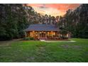 Lovely brick home featuring a manicured lawn, and a welcoming front porch at 152 Candace Dr, Ridgeville, SC 29472
