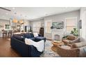 Open-concept living area with a modern fireplace, hardwood floors, and a comfortable sectional sofa at 158 Darlington Ave, Charleston, SC 29403