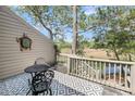 Outdoor patio features a table and chairs, plus scenic views of marshland and trees at 166 River Breeze Dr, Charleston, SC 29407