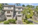 Charming townhouse featuring well-maintained landscaping and private garage space in a desirable community at 166 River Breeze Dr, Charleston, SC 29407