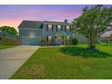 Beautiful two-story home with manicured lawn, offering great curb appeal under a vibrant sky at 208 Waterford Ln, Summerville, SC 29483