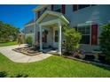 Inviting front porch with decorative plants, a small seating area, and classic home number display at 208 Waterford Ln, Summerville, SC 29483