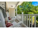 Inviting front porch with rocking chairs and a view of the green landscape at 214 Blackstone Dr, Moncks Corner, SC 29461