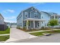 Charming two-story blue home with a detached garage and extended driveway at 238 Bird Song Path, Summerville, SC 29485