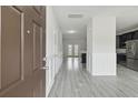 Inviting foyer with stylish gray wood floors, modern wainscoting, and views into the open floorplan at 242 Swallowtail Ln, Goose Creek, SC 29445