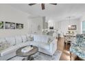 Bright and airy living room with a cozy sofa and seamless flow to the dining area at 2467 Bergeron Way, Mount Pleasant, SC 29466