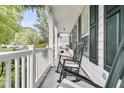 Inviting front porch featuring rocking chairs, perfect for relaxing outdoors at 2467 Bergeron Way, Mount Pleasant, SC 29466