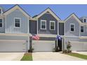 Charming townhome with a well-maintained exterior, multiple garages, and visible American and South Carolina flags at 2648 Balena Dr, Mount Pleasant, SC 29466