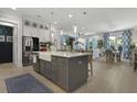 Open-concept kitchen featuring a large kitchen island, pendant lighting, and stainless steel appliances at 2648 Balena Dr, Mount Pleasant, SC 29466