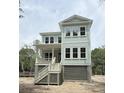 New two-story house with pale siding, elevated with stairs to front porch at 2790 Burden Creek Rd, Johns Island, SC 29455