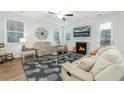 Cozy living room featuring a fireplace, comfortable seating, and bright natural light at 297 Red Leaf Blvd, Moncks Corner, SC 29461