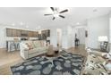 Open concept living room with a view into the kitchen, featuring hardwood floors and stylish decor at 297 Red Leaf Blvd, Moncks Corner, SC 29461