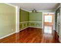 Spacious living room featuring elegant crown molding, wainscoting, and gleaming hardwood floors at 3632 Locklear Ln, Mount Pleasant, SC 29466
