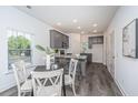 Eat in kitchen featuring gray cabinets, granite counters, stainless appliances, and dining table at 404 Gravy Train St, Charleston, SC 29414
