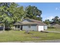 Inviting exterior showcasing blue siding, a well-manicured lawn, and an attached garage, offering suburban charm at 406 Carolina Cir, Ladson, SC 29456