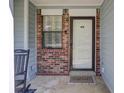 Welcoming front entrance featuring brick accents and a 'HOME' doormat, creating an inviting curb appeal at 406 Carolina Cir, Ladson, SC 29456