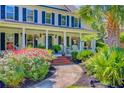 Inviting home exterior with a covered porch and colorful landscaping at 4227 Sawgrass Dr, North Charleston, SC 29420