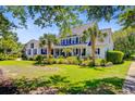 Beautiful two-story home with a spacious yard and lush landscaping at 4227 Sawgrass Dr, North Charleston, SC 29420