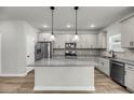 Modern kitchen boasts stainless appliances, an island with gray counters, and stylish gray cabinets at 4308 Cotton Flt Rd, Summerville, SC 29485