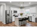 Modern kitchen features stainless steel appliances, island with bar stools, and pendant lighting at 513 Donnas View Way, Summerville, SC 29486