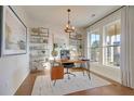 Stylish home office with bright windows and an eye-catching display of artwork and shelving, promoting productivity at 515 Ivy Green Ln, Summerville, SC 29486