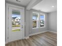 Bright, airy room with hardwood floors, with a door leading outside and two large windows at 515 Ivy Green Ln, Summerville, SC 29486