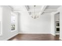 Elegant dining room featuring coffered ceilings, a modern chandelier, and hardwood floors at 517 Yukon Ct, Summerville, SC 29485