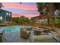 Serene backyard with a pool, spa, fire pit, and comfortable seating, perfect for entertaining at 764 Post Oak Dr, Mount Pleasant, SC 29464