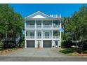 Charming two-story home with multiple balconies, lush landscaping, and a spacious driveway at 764 Post Oak Dr, Mount Pleasant, SC 29464