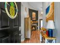 Inviting entryway featuring wood floors, a view of the fireplace, and coastal-themed décor at 7886 Racquet Rd, North Charleston, SC 29418