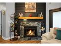 Elegant fireplace with stone surround, mantel and hearth, perfect for cozy evenings in the living room at 7886 Racquet Rd, North Charleston, SC 29418