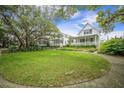 Beautiful homes surrounded by lush lawns and mature trees create a serene setting at 7935 Flagship Ln, Johns Island, SC 29455