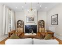 Cozy living room with fireplace, hardwood floors, stylish furnishings, and abundant natural light at 80 Smith St, Charleston, SC 29401