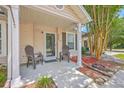 Close-up of front porch with rocking chairs, a well-manicured garden, and a welcoming entrance at 8028 Vermont Rd, North Charleston, SC 29418
