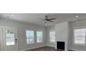 Bright living room featuring modern fireplace, ceiling fan, and abundant natural light at 819 Burger St, Charleston, SC 29407