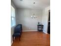 Bright dining room with hardwood floors and elegant chandelier lighting fixture at 9217 Southern Oak Ln, Ladson, SC 29456
