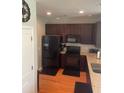 Modern kitchen with stainless steel appliances, granite countertops, and dark wood cabinetry at 9217 Southern Oak Ln, Ladson, SC 29456