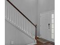 Bright entryway featuring a staircase with wooden accents and a white door, offering a fresh welcome at 9923 Honeylocust Ln, Ladson, SC 29456