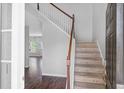 Welcoming foyer with hardwood floors, staircase, and abundant natural light, creating an inviting atmosphere at 9923 Honeylocust Ln, Ladson, SC 29456