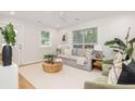 Bright living room featuring neutral paint, a ceiling fan, modern decor, and a comfortable seating area at 1010 Fiall St, Charleston, SC 29407