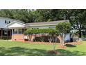 A tidy home with manicured lawn, tidy landscaping, and a brick foundation, set in a green neighborhood at 105 Pandora Dr, Goose Creek, SC 29445