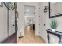 Welcoming entryway with light wood floors, elegant decor, and a view into the open living space at 1093 Ave Of Oaks, Charleston, SC 29407