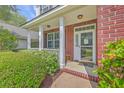 Inviting front entrance with decorative columns and well-maintained landscaping at 111 Kapalua Run, Summerville, SC 29483