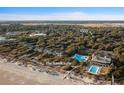 Aerial view of The Sandcastle community showcasing lush landscaping, pools, and proximity to the beach at 1355 Dunlin Ct # Share D, Kiawah Island, SC 29455