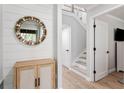 Inviting entryway with wood-look floors, board and batten accent wall, and decorative mirror at 1355 Dunlin Ct # Share D, Kiawah Island, SC 29455
