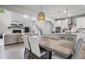 Spacious dining area offering an open floor plan to the living room and kitchen at 1387 Thin Pine Dr, Johns Island, SC 29455