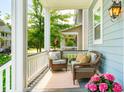 Relaxing front porch featuring comfortable seating, outdoor rug, and neighborhood views at 1446 Crane Creek Dr, Mount Pleasant, SC 29466