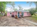 Charming pink single-story home with tidy landscaping offering great curb appeal at 1514 Patterson Ave, Charleston, SC 29412