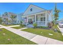 Well-maintained home featuring a charming front porch, a verdant lawn, and a paved walkway at 1787 Timmons St, Mount Pleasant, SC 29466